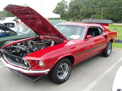2007 Ford Mustang - A red 1969 Ford Mustang Mach 1 is displayed with its hood open, revealing the engine bay.