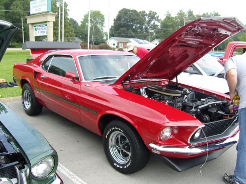 2007 Ford Mustang - A red 1969 Ford Mustang Mach 1 is displayed with its hood open, revealing the engine.