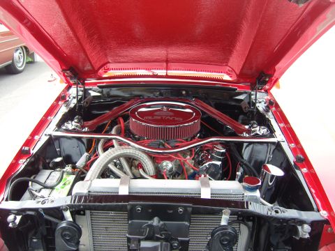 2007 Ford Mustang - Engine bay of a red 1967 Ford Mustang, a chrome air cleaner with Mustang branding.