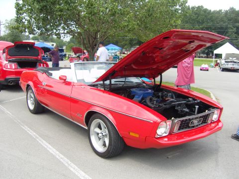 2007 Ford Mustang - A red 1971 Ford Mustang convertible is displayed with its hood open at a car show.