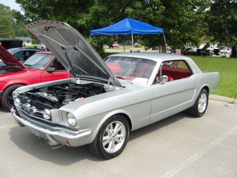 2007 Ford Mustang - Silver 1965 Ford Mustang coupe on display with its hood open, showing the engine bay.