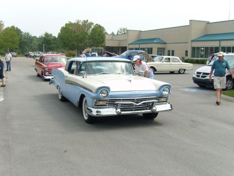 2007 Ford Mustang - A classic 1957 Ford Fairlane is shown in a procession of vehicles.