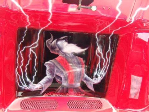 2007 Ford Mustang - Custom airbrushed wizard and lightning design adorns the red hood interior of a vehicle.