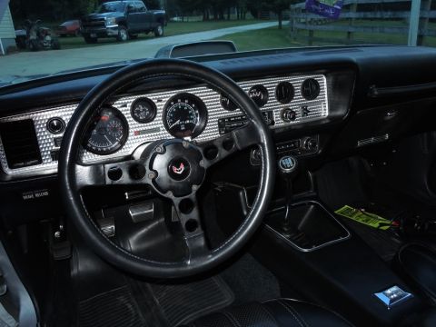 1976 Pontiac Trans Am - Interior view of a 1976 Pontiac Trans Am, an aftermarket steering wheel and a diamond-patterned dash.