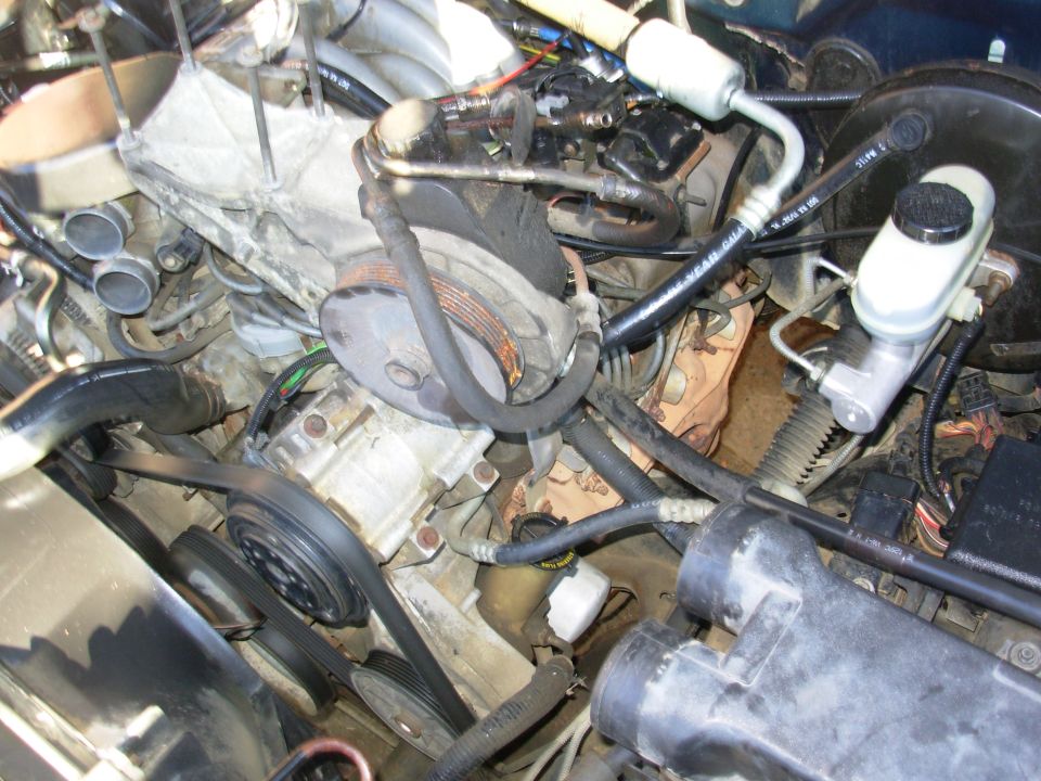 Engine bay with power steering pump, AC compressor and brake master cylinder