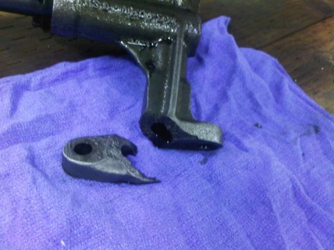 1979 Ford Bronco - A close-up view of a broken metal engine component resting on a purple cloth.