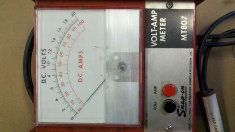 1970 Ford Bronco - A close-up of a Snap-on Volt-Amp Meter, showing its dual-scale analog display and control buttons.