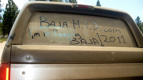 1996 Ford Bronco - Writing on the dusty rear window of a vehicle indicates a Baja event in 2011.
