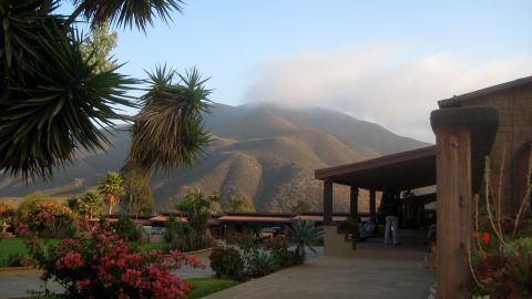1996 Ford Bronco - A scenic view of a mountain landscape with a building and plants in the foreground.