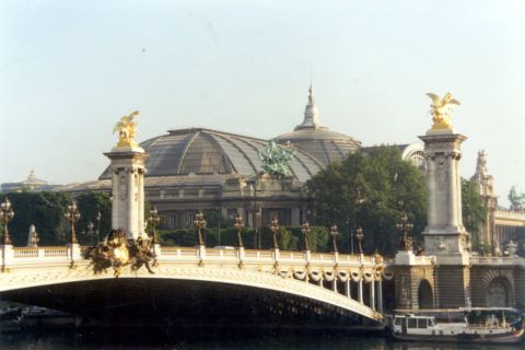 1969 Lincoln Continental - The ornate Pont Alexandre III bridge spans the Seine River in Paris, with the Grand Palais visible behind it.