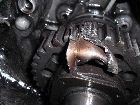 1991 Ford Bronco - Close-up of severely damaged transfer case gears, indicating significant mechanical failure.