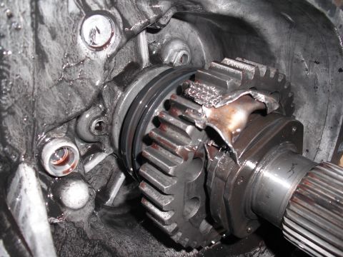 1991 Ford Bronco - Close-up view of severely damaged gears within a vehicle's transfer case.
