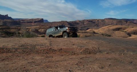 1990 Ford Bronco - Shawn crests a climb with an incredible background
