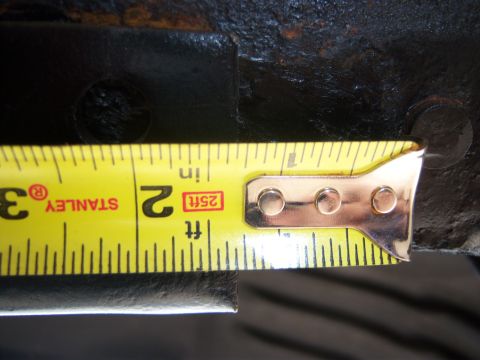 1996 Ford Bronco - Close-up of a metal part being measured with a Stanley tape measure.