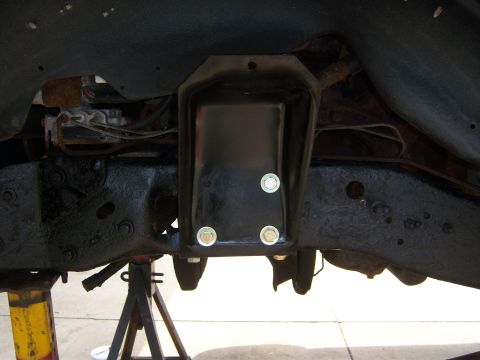 1996 Ford Bronco - A black frame mount bracket is bolted to the vehicle's chassis, viewed from underneath.
