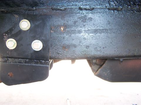 1996 Ford Bronco - This image shows a section of a vehicle's frame, highlighting its rusty condition and bolted components.