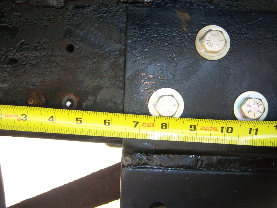 Measuring frame section with tape measure showing 8 inches
