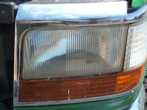 1995 Ford Bronco - Headlight assembly detail on a 1992 Ford Bronco, showing the clear lens and amber marker light.