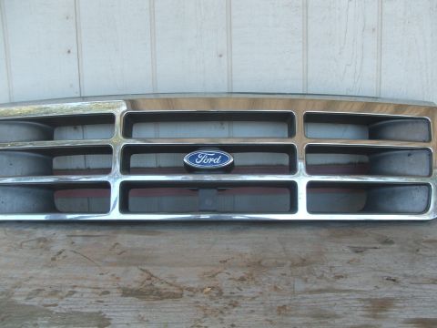1995 Ford Bronco - A close-up of a Ford grille, detached from a vehicle.