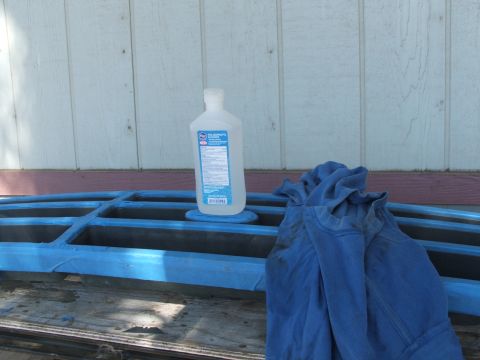 1995 Ford Bronco - Rubbing alcohol and a t-shirt are placed on a blue grille.
