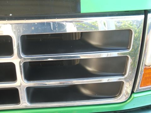 1995 Ford Bronco - Close-up of a 1992 Ford Bronco grille, showing chrome trim and rectangular openings.