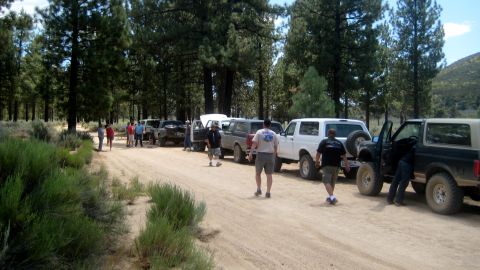 1996 Ford Bronco - Multiple Ford Broncos gathered on a dirt road during an outdoor excursion.