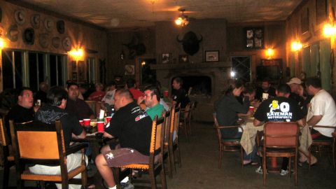 1996 Ford Bronco - A group of people are seated around tables in a room decorated with mounted animal heads and hats.