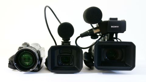 1993 Ford Taurus - A collection of professional video cameras and a camcorder are displayed against a white background.