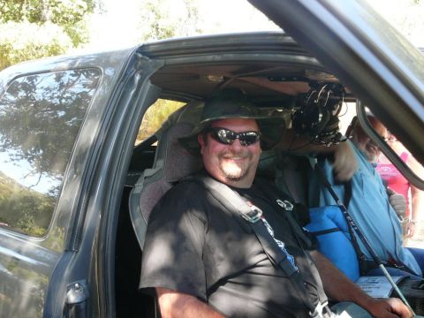 1988 Ford Bronco - Interior view of a modified vehicle with two men inside, one wearing a hat and sunglasses.