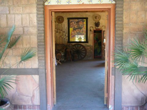 1988 Ford Bronco - The room is decorated with a large movie poster, wagon wheel, and various western artifacts.