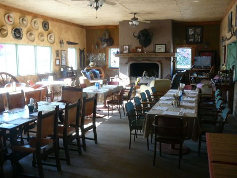 1988 Ford Bronco - A rustic restaurant interior is set for dining with tables, chairs, and decorative elements.