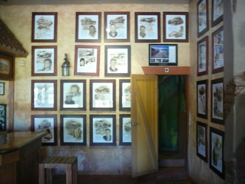 1988 Ford Bronco - A collection of framed photographs vintage automobiles and individuals adorns the wall of this establishment.
