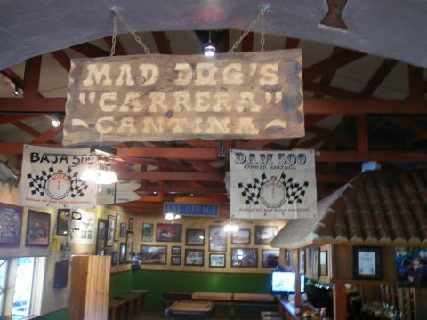 1988 Ford Bronco - Mad Dog's Carrera Cantina interior features racing memorabilia and photos on the walls.