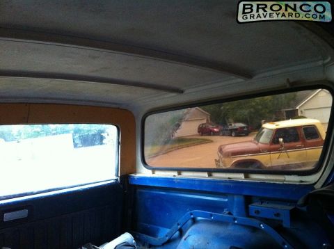 1978 Ford Bronco - View from inside a Bronco shows a two-tone brown and yellow Bronco parked outside, with other vehicles visible.