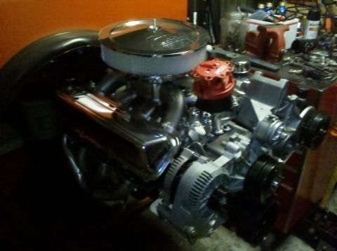 1994 Ford Bronco - A V8 engine with chrome valve covers and an aftermarket air cleaner sits on a workbench.