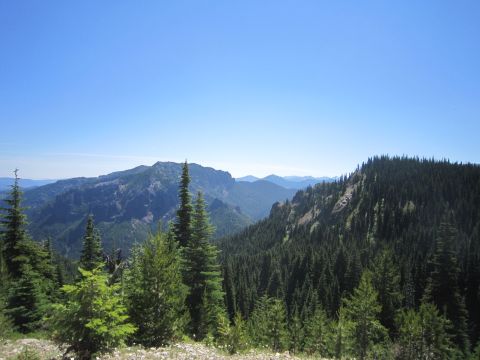 2008 Jeep Wrangler - A scenic view of forested mountains and valleys under a bright blue sky.