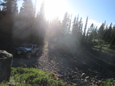 2008 Jeep Wrangler - Two Jeep Wranglers navigate a steep, rocky mountain path under bright sun.