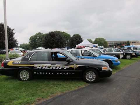 1991 Ford LTD Crown Victoria - black Ford Crown Victoria marked Sheriff Hampden County with a gold stripe and unit 53 sits in a row of vehicles.
