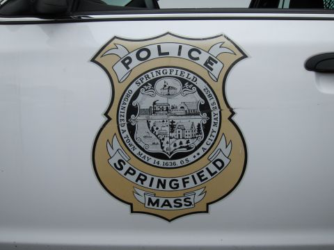 1991 Ford LTD Crown Victoria - Close-up of a Springfield, Mass. police department badge seal decal on the white door of a patrol vehicle.