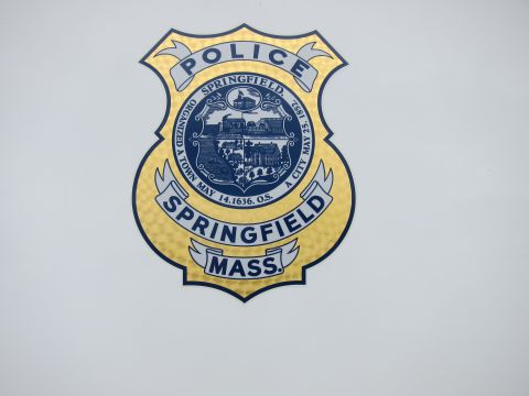 1991 Ford LTD Crown Victoria - Close-up of a blue-and-gold Springfield, Mass. police department badge seal decal on a vehicle body panel.