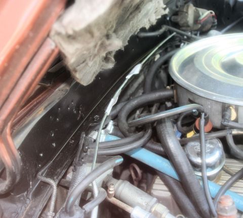 1980 Ford Mustang - Close-up view of engine components including hoses and air cleaner assembly.