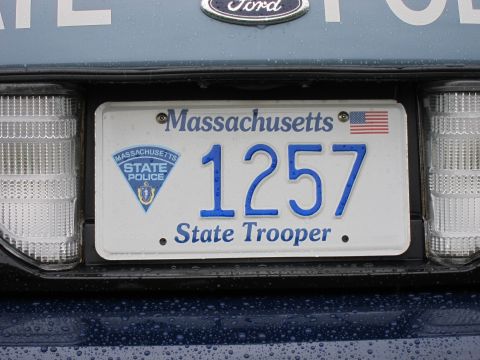 1991 Ford LTD Crown Victoria - Close-up of a white Massachusetts 'State Trooper' license plate reading 1257, mounted on a Ford rear bumper.
