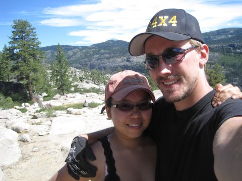 1989 Ford Bronco - A couple smiles for a selfie while enjoying a scenic mountain view on a sunny day.