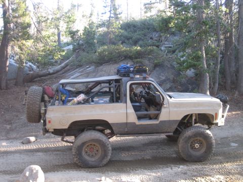 1989 Ford Bronco - Off-road SUV with extensive modifications for rough terrain, including a roll cage and large tires.