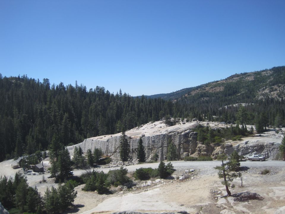 Mountain landscape with a road winding through trees and rock formations