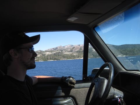 1989 Ford Bronco - View from inside a vehicle looking out at a scenic lake and mountain landscape on a clear day.