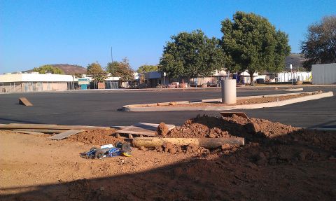 1992 Ford Ranger - A remote control car lies on a pile of dirt in a construction area.