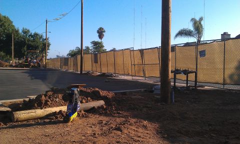 1992 Ford Ranger - A construction site features a yellow backhoe and a chain-link fence under a clear blue sky.