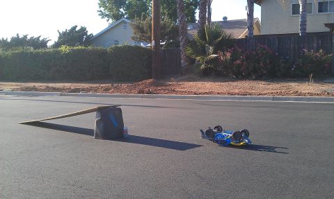1992 Ford Ranger - A blue remote control car lies on its side after an apparent mishap with a ramp.