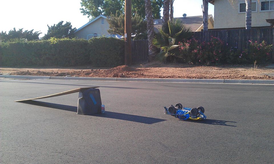 Blue remote control car flipped on its side